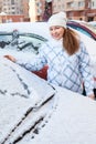 Attractive woman and snowy car with drawing heart shape Royalty Free Stock Photo