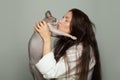 Attractive woman and sphinx cat pet on gray background