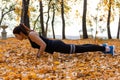 Khabarovsk, Russia - Oct 07, 2018: An attractive woman in sports clothes doing sports exercises in nature against the sunset and