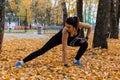 Khabarovsk, Russia - Oct 07, 2018: An attractive woman in sports clothes doing sports exercises in nature against the sunset and