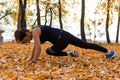 Khabarovsk, Russia - Oct 07, 2018: An attractive woman in sports clothes doing sports exercises in nature against the sunset and