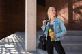 Attractive woman in sportswear walking to a gym outdoor. Sport, jogging, healthy and active lifestyle. Royalty Free Stock Photo