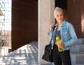 Attractive woman in sportswear walking to a gym outdoor. Sport, jogging, healthy and active lifestyle. Royalty Free Stock Photo