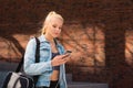 Attractive woman in sportswear walking to a gym outdoor. Sport, jogging, healthy and active lifestyle. Royalty Free Stock Photo