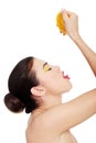 Attractive woman squeezing orange juice straight to mouth. Royalty Free Stock Photo