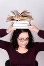 Attractive woman with stack of books