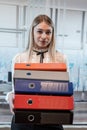 Attractive woman standing alone at the office and hold folder for paper documents Royalty Free Stock Photo