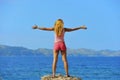 Attractive woman standing with arms open to the air free in front of the sea Royalty Free Stock Photo