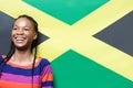 Attractive woman standing in front of Jamaican flag