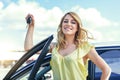 An attractive woman standing near the car holds a car key in her hand. Royalty Free Stock Photo