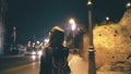 Attractive woman standing near the Colosseum in Rome, Italy and using smartphone. Girl walking and talking on the phone. Royalty Free Stock Photo