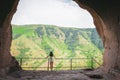 Attractive Woman stands in giant cave Royalty Free Stock Photo