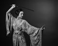 Attractive woman in traditional Japanese kimono with katana  japanese sword Royalty Free Stock Photo