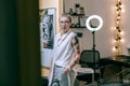 Attractive woman with unusual appearance working as tattoo master