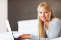 Attractive woman using laptop. Closeup of beautiful young woman working on laptop. Royalty Free Stock Photo