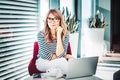 Attractive woman using laptop while working from home Royalty Free Stock Photo