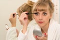 Attractive woman using mascara eyeliner Royalty Free Stock Photo