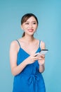 Attractive woman using text messaging feature on her portable device in studio Royalty Free Stock Photo