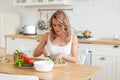 Attractive woman with vegetable in her kitchen. Healthy eating Royalty Free Stock Photo