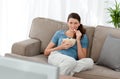 Attractive woman watching television and eating Royalty Free Stock Photo