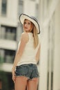 Attractive woman wearing sun hat and white top