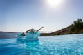 Woman enjoys the view to the Mediterranean sea floating on a infinity pool Royalty Free Stock Photo