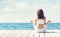 Attractive woman in white sporty clothes doing yoga on a wooden Royalty Free Stock Photo