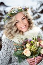 Attractive woman with white teeth and a perfect smile holds a bouquet. Happy sincere winter outdoor portrait Royalty Free Stock Photo