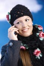 Attractive woman in winter clothes with mobile Royalty Free Stock Photo