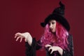 Attractive woman in witches hat and costume with red hair. Halloween Royalty Free Stock Photo