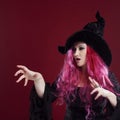 Attractive woman in witches hat and costume with red hair. Halloween Royalty Free Stock Photo