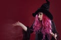 Attractive woman in witches hat and costume with red hair. Halloween Royalty Free Stock Photo