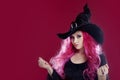 Attractive woman in witches hat and costume with red hair. Halloween Royalty Free Stock Photo