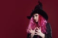 Attractive woman in witches hat and costume with red hair. Halloween Royalty Free Stock Photo