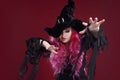 Attractive woman in witches hat and costume with red hair. Halloween Royalty Free Stock Photo