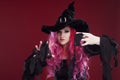 Attractive woman in witches hat and costume with red hair. Halloween Royalty Free Stock Photo