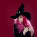 Attractive woman in witches hat and costume with red hair. Halloween Royalty Free Stock Photo