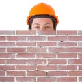 Attractive Woman Worker in Safety Yellow Helmet behind Blank Brick Wall with Free Space for Yours Design Royalty Free Stock Photo