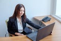 Attractive woman working in office on laptop Royalty Free Stock Photo