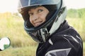 Attractive woman 60 years old in a motorcycle helmet looking at the camera. Close-up portrait
