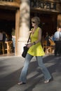 Attractive woman in yellow dress walking on Passeig de GrÃ¯Â¿Â½cia in the Eixample district, busy street in Barcelona, Spain, Europe