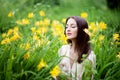 Attractive woman in yellow flowers day-lily field Royalty Free Stock Photo