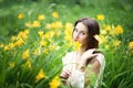 Attractive woman in yellow flowers day-lily field Royalty Free Stock Photo