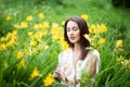 Attractive woman in yellow flowers day-lily field Royalty Free Stock Photo