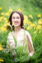 Attractive woman in yellow flowers day-lily field Royalty Free Stock Photo