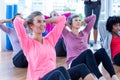 Attractive women doing sit ups on hardwood floor Royalty Free Stock Photo