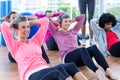 Attractive women doing sit ups on hardwood floor Royalty Free Stock Photo