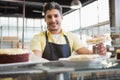 Attractive worker in apron posing