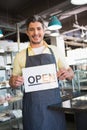 Attractive worker holding open sign