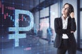 Attractive worried young business woman with abstract glowing falling forex chart with dollar sign on blurry interior background. Royalty Free Stock Photo